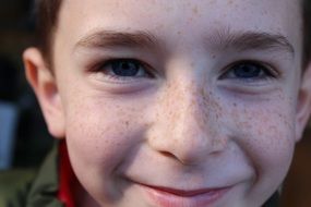 happy girl with freckles on her face