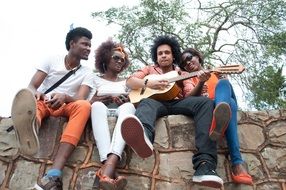 african musicians on the stone wall