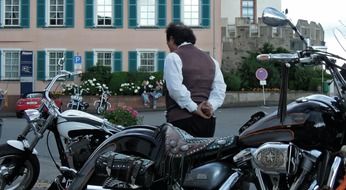 pensive man near a motorcycle