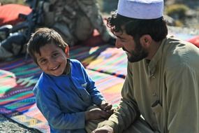 afghan smiling boy with father