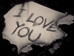I love you text on burned paper