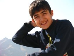 photo of a boy on the background of the Caucasus Mountains