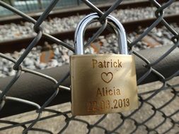 lover&#039;s padlock attached to fence