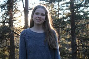 young blonde girl at forest, portrait in back light