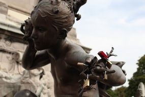 statue of a girl with hanging love locks