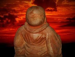 Statue of the Buddha on the sunset