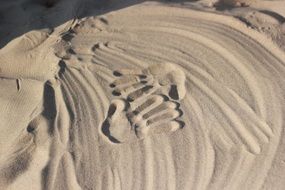 Handprints on the sand on the beach