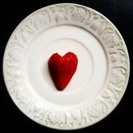 heart form strawberry on white plate