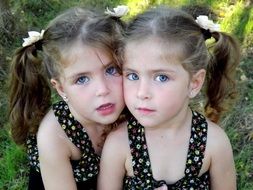 Two sisters twins in sundresses