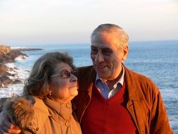 elderly couple on the background of the sea in autumn