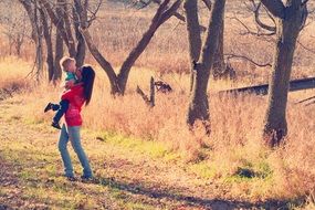sister carries brother in her arms