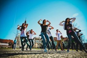 young girls rehearsing dance in the street