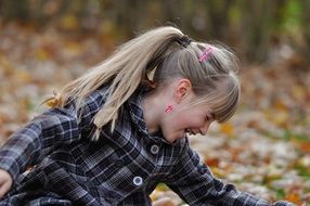 happy girl among autumn foliage