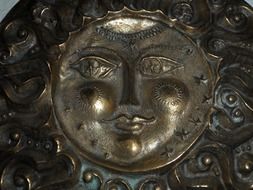 metal relief with a face