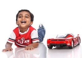 happy boy with red sport car