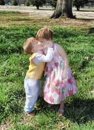children stand on green grass