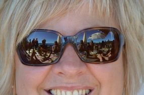 smiling blonde in sunglasses close-up