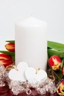 White candle with a decor to the day of the holy valentine