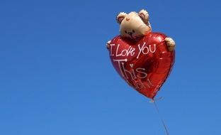 balloon in the shape of a bear hugging a heart