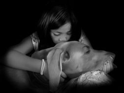 girl is kissing Weimaraner
