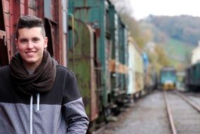 young man on the background of railway wagons