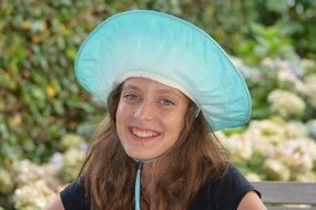 smiling teen in a hat