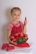 cute girl with plate of vegetables