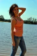 girl in a t-shirt posing by the lake