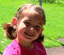 Flap-eared smiling girl cheerful green grass