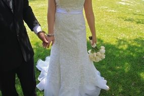 bride and groom on green grass