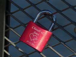 Pink love lock on the fence