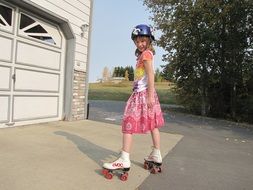 girl in a dress rollerblading