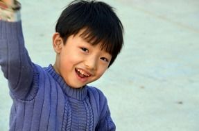 asian child boy with hand up