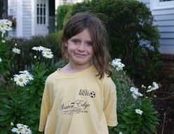 girl in a yellow T-shirt on the background of the garden