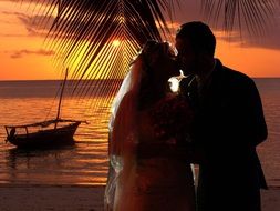 wedding kissing couple at sunset by sea