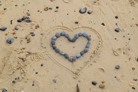 heart stones on sand