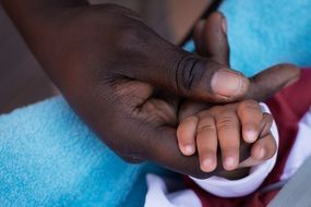 child's hand in father's hand