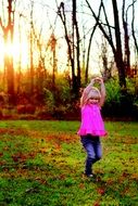 little girl dancing in nature