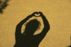shadow of a girl with a heart over her head