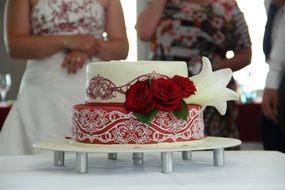 stylish wedding cake with red roses