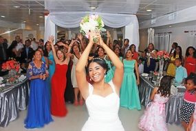 bride throws a bouquet at a wedding