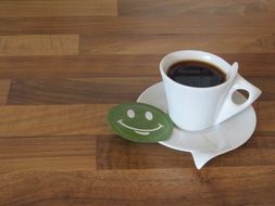 coffee cup with green smiley