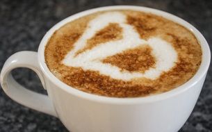 cup of cappuccino with milky foam