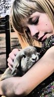 girl petting gray rabbit