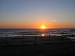 Colorful sunset on horizon from view from the coast