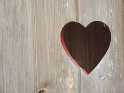 heart form hole in wooden panel