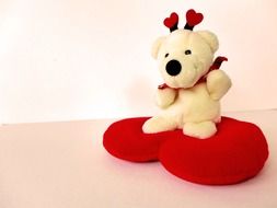 white teddy bear on red heart for valentines day