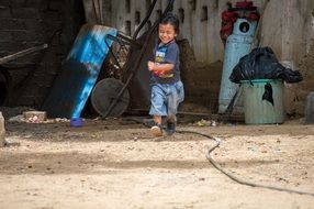 asian child boy running in back yard