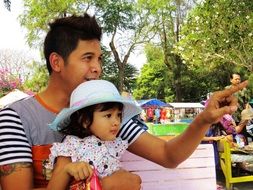 father with baby on vacation in the park