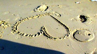 heart painted on beach sand